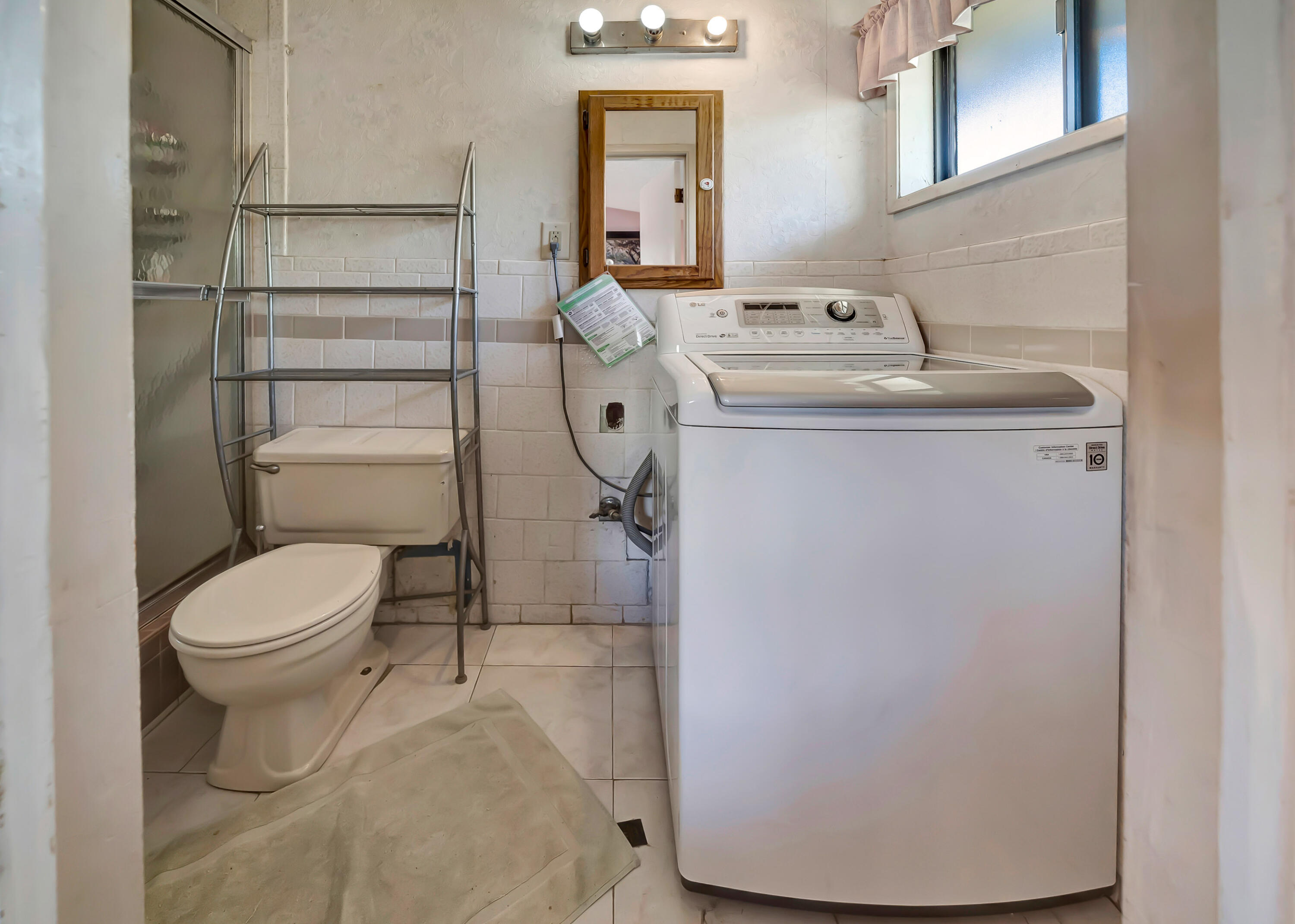 1617 Elizabeth Lake Road Palmdale, CA 93551 - Photo 25 of 45 a bathroom with a sink toilet and mirror