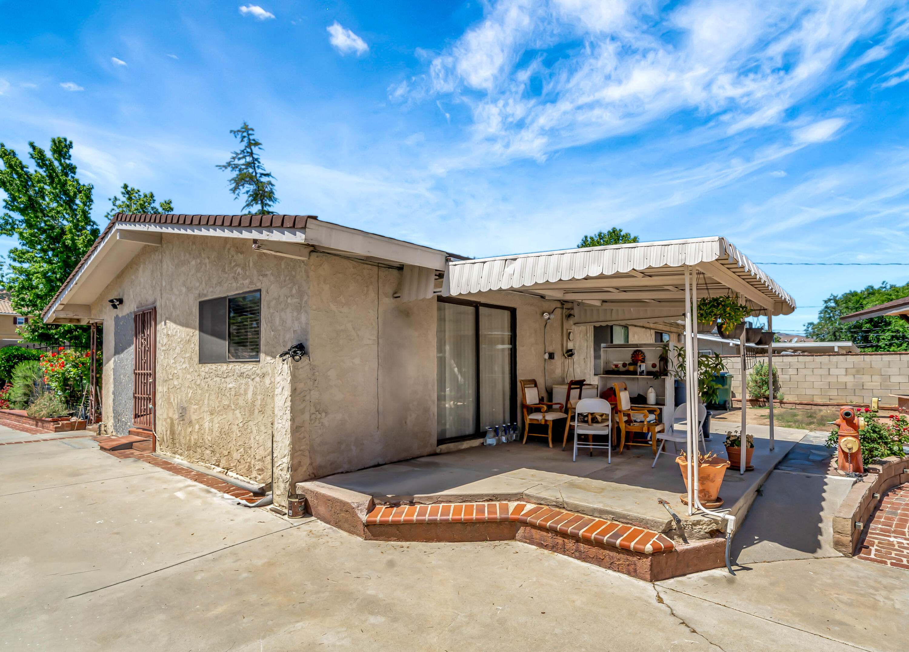 1617 Elizabeth Lake Road Palmdale, CA 93551 - Photo 29 of 45 a view of a patio with a table and chairs under an umbrella