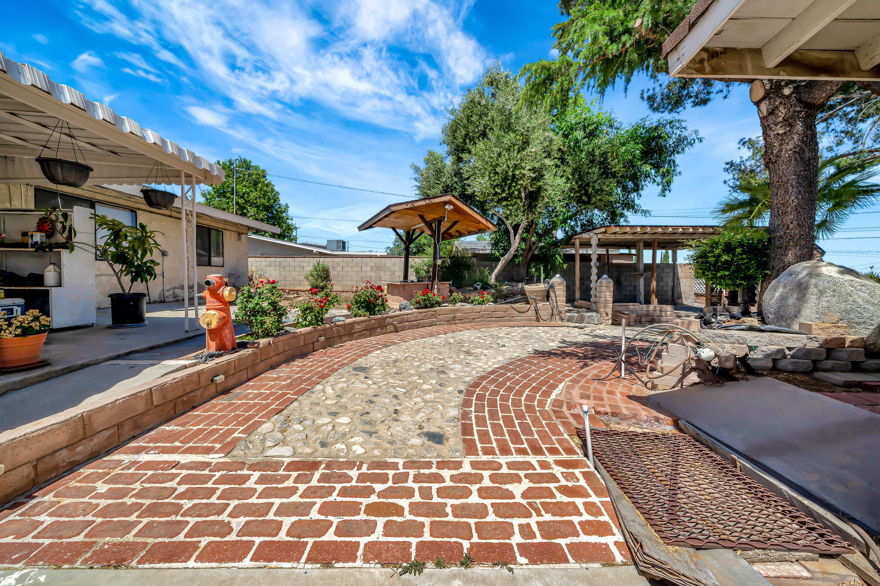 1617 Elizabeth Lake Road Palmdale, CA 93551 - Photo 30 of 45 a view of a brick house with a patio