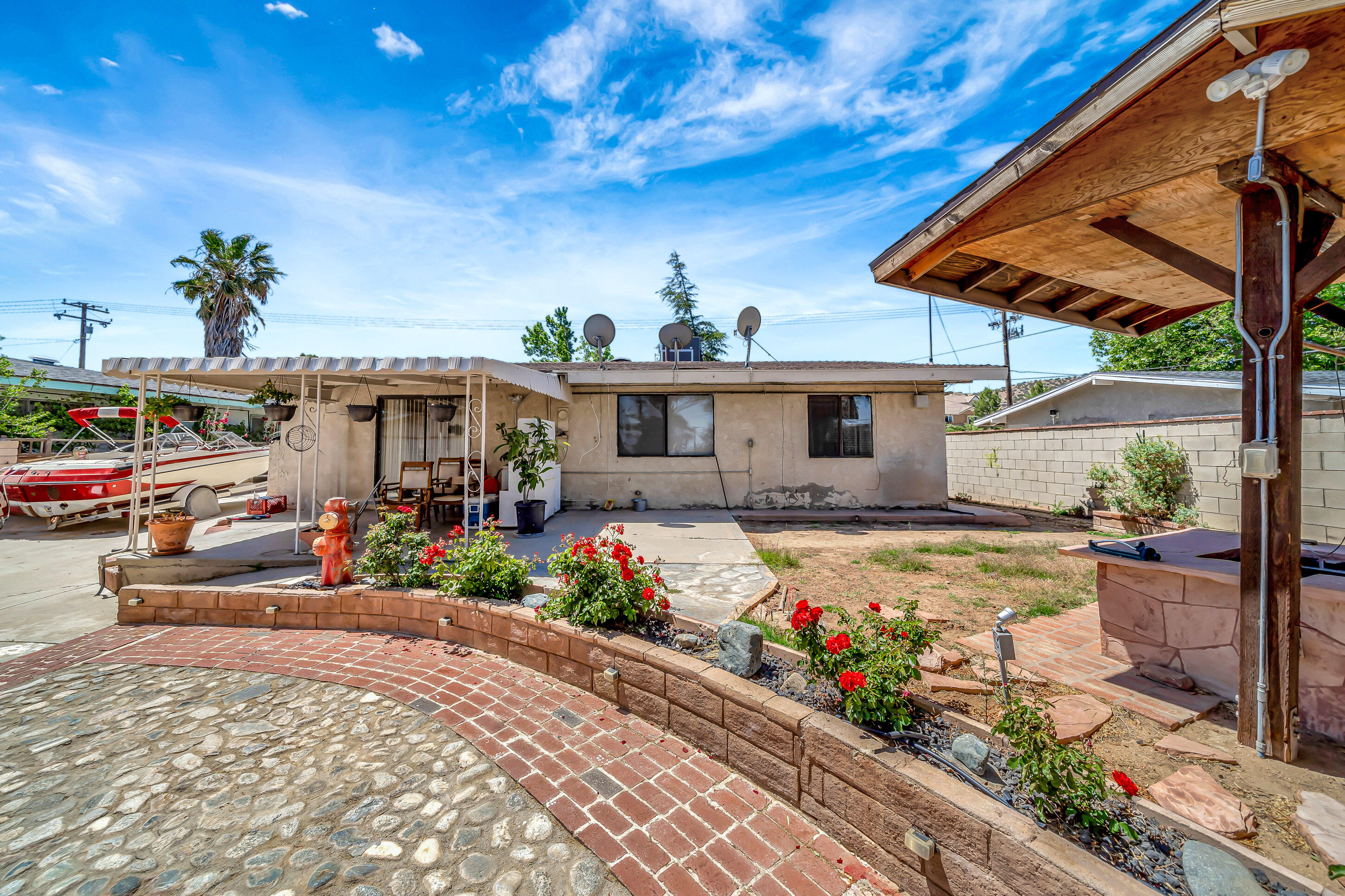1617 Elizabeth Lake Road Palmdale, CA 93551 - Photo 31 of 45 a view of a house with a yard and sitting area