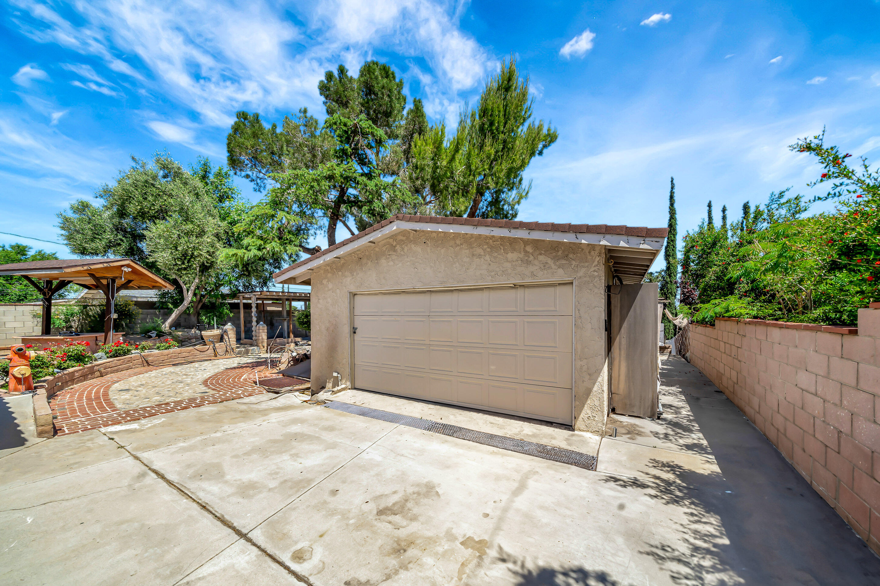 1617 Elizabeth Lake Road Palmdale, CA 93551 - Photo 36 of 45 a backyard of a house with table and chairs under an umbrella