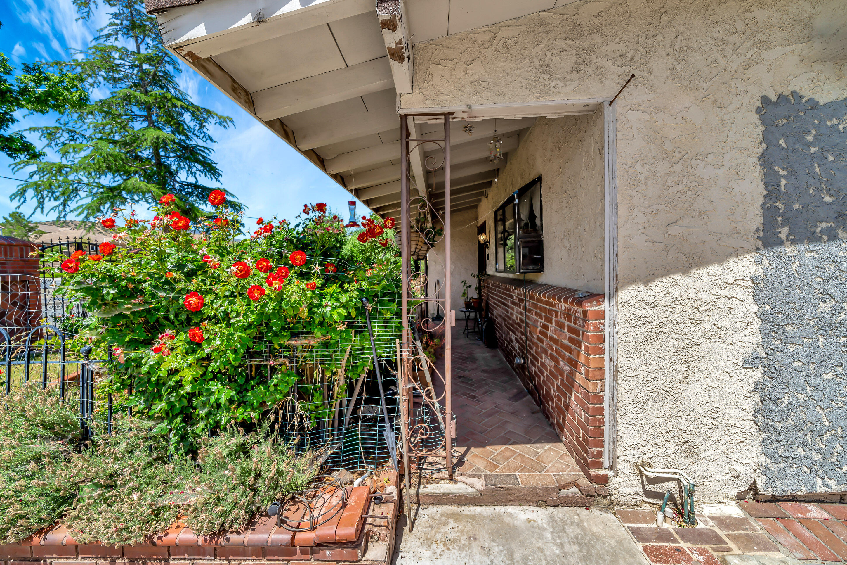 1617 Elizabeth Lake Road Palmdale, CA 93551 - Photo 42 of 45 a view of path along with house and flowers