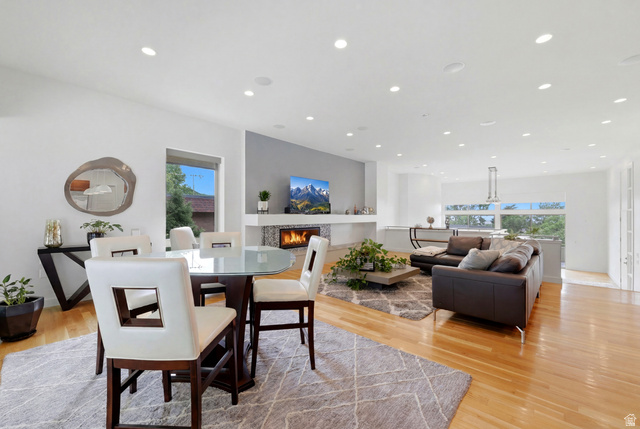 1389 Millbrook Way Bountiful, UT 84010 - Photo 23 of 74 Open-concept living area featuring wood-finish flooring, recessed lighting, a modern fireplace with a tiled surround, and large windows