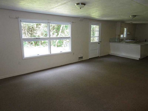 3147 Flat River Road Coventry, RI 02816 - Photo 21 of 24 an empty room with a fireplace and windows