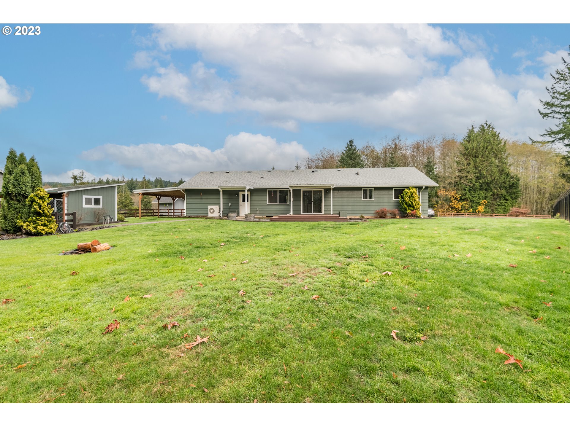 915 Fall Creek Road Longview, WA 98632 - Photo 22 of 31 a view of a house with a big yard and large trees