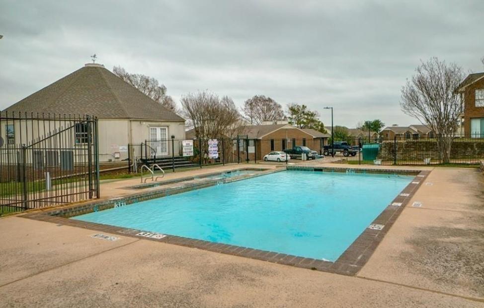 4448 Chaha Road Garland, TX 75043 - Photo 4 of 18 Rectangular swimming pool with surrounding concrete decking, secured by a wrought iron fence