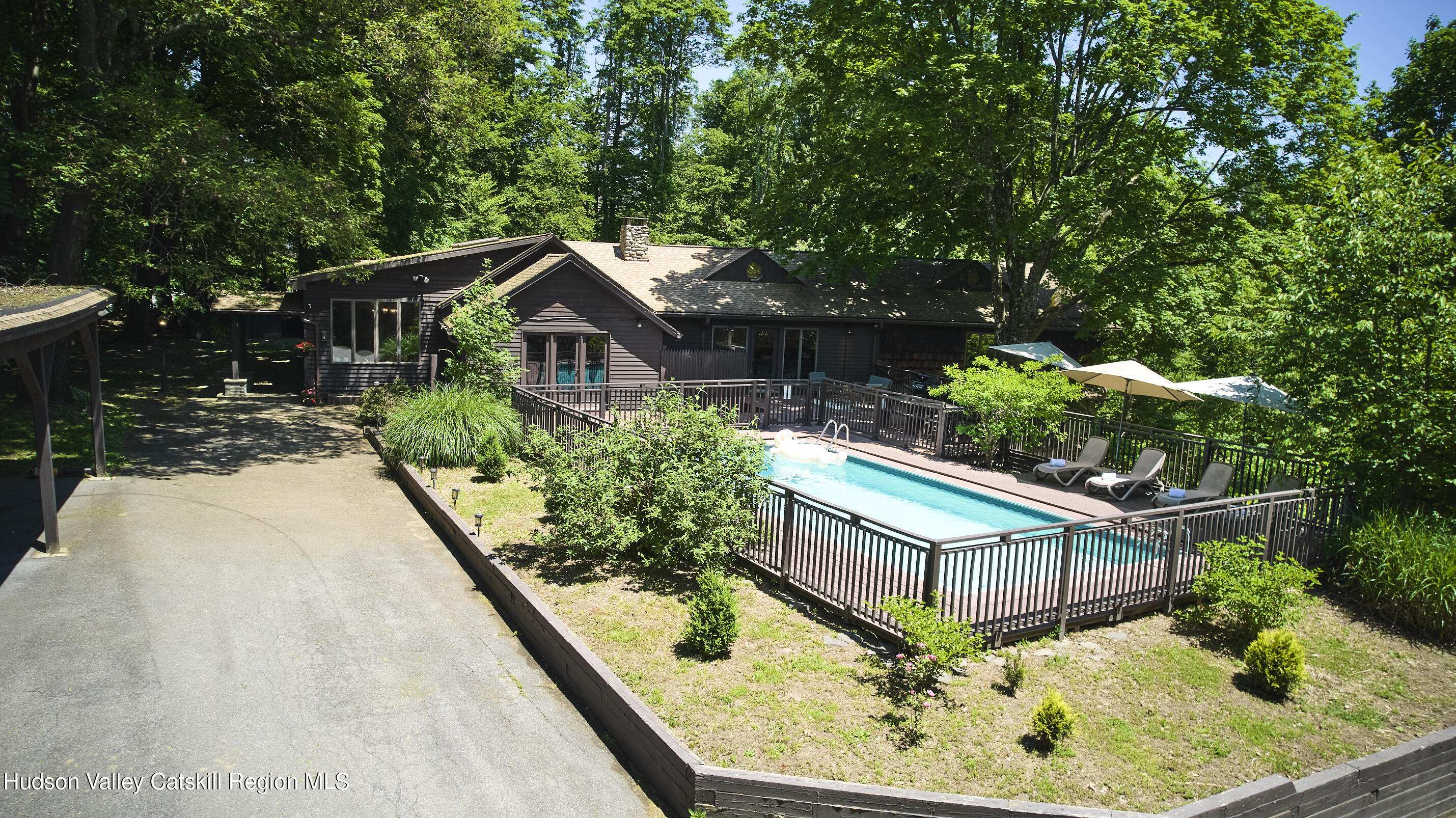 284 Dewitt Mills Road Kingston, NY 12401 - Photo 35 of 36 a backyard of a house with large trees and plants