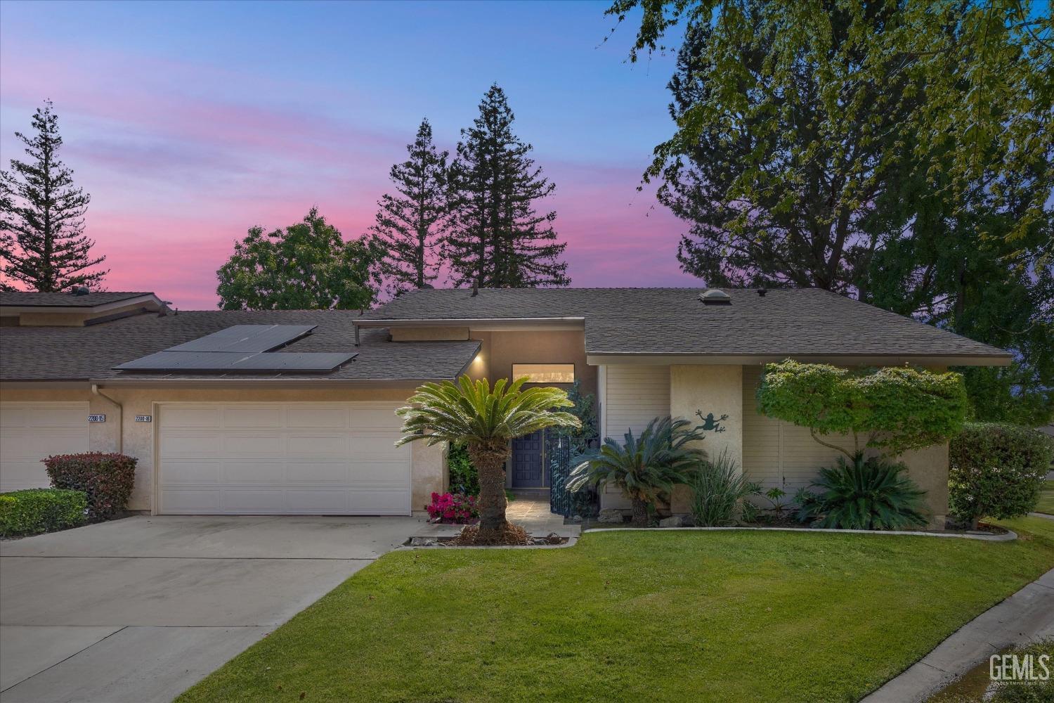 a front view of a house with garden