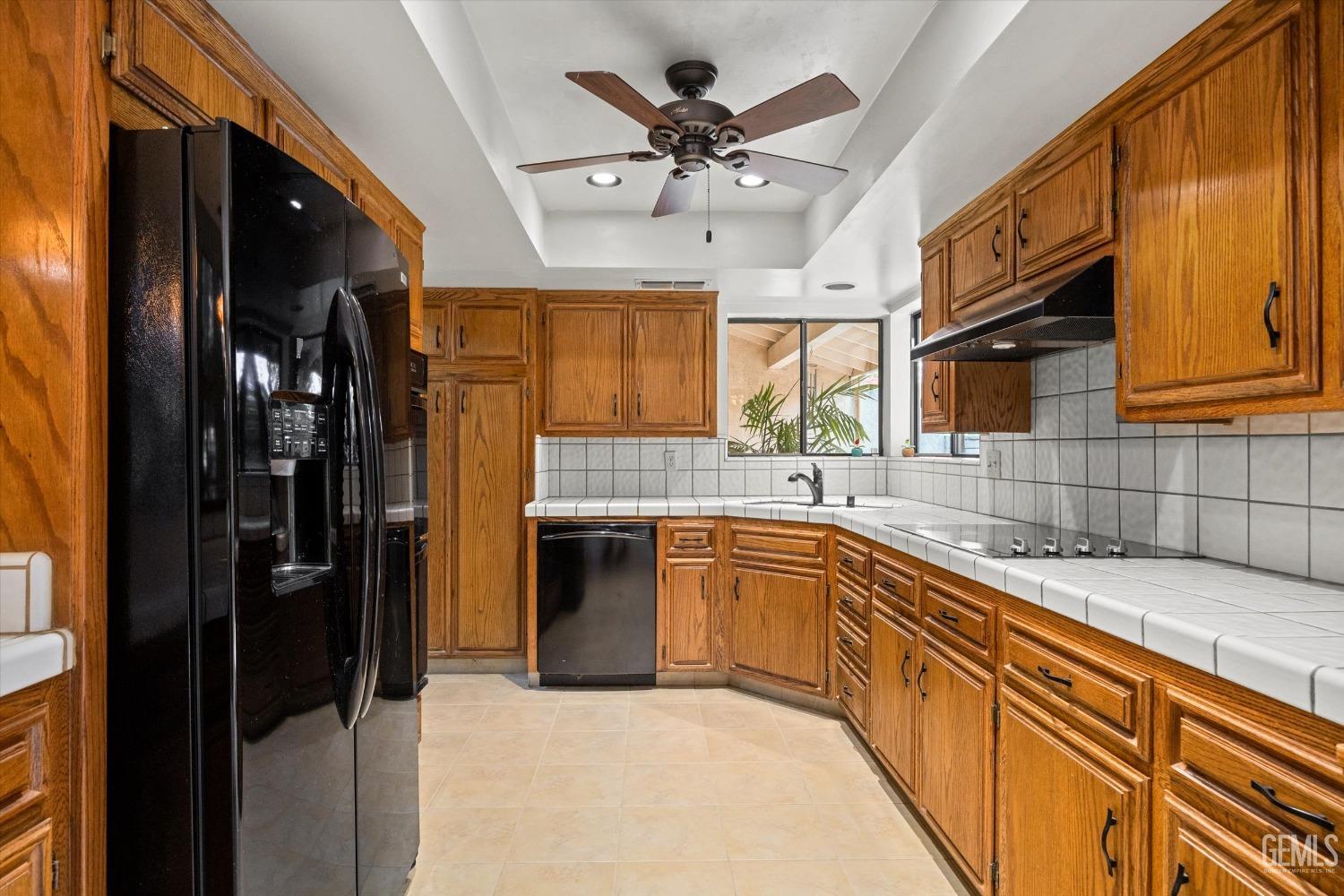 Undisclosed Address Bakersfield, CA 93309 - Photo 12 of 36 a kitchen with stainless steel appliances granite countertop a refrigerator a sink dishwasher a stove and white cabinets with wooden floor