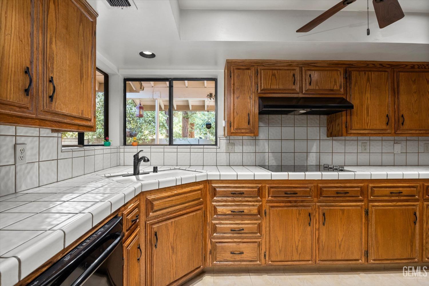 Undisclosed Address Bakersfield, CA 93309 - Photo 14 of 36 a kitchen with granite countertop a sink a stove and cabinets