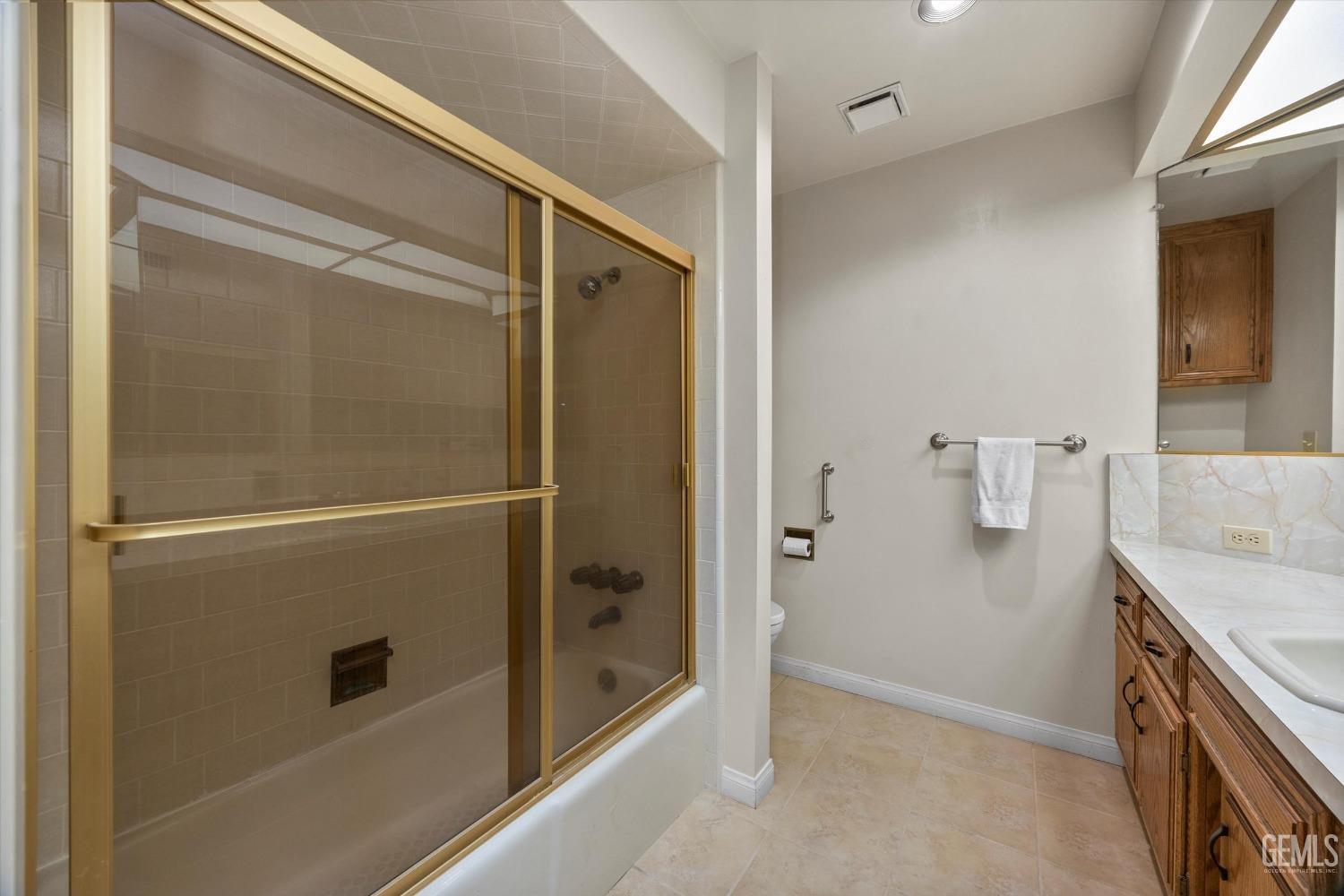 Undisclosed Address Bakersfield, CA 93309 - Photo 21 of 36 a bathroom with a granite countertop shower mirror and a sink