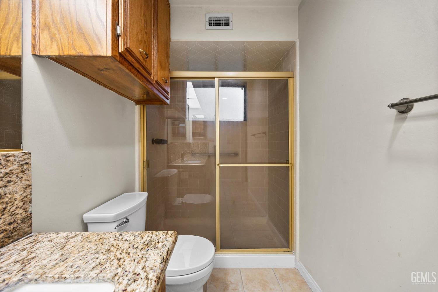 Undisclosed Address Bakersfield, CA 93309 - Photo 25 of 36 a bathroom with a toilet and a shower