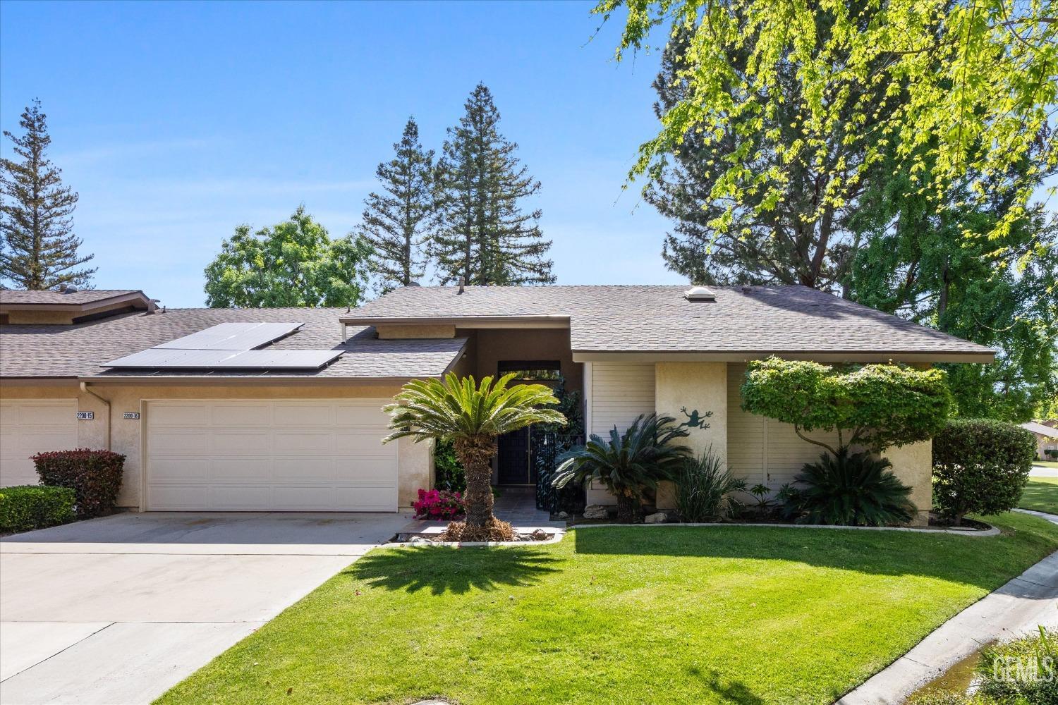 Undisclosed Address Bakersfield, CA 93309 - Photo 3 of 36 a front view of a house with garden