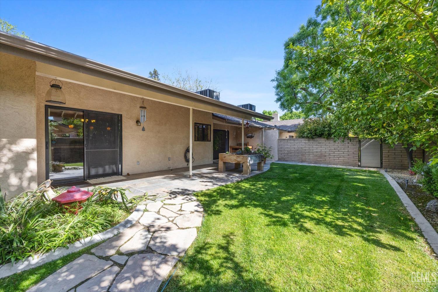 Undisclosed Address Bakersfield, CA 93309 - Photo 35 of 36 a backyard of a house with garden and plants