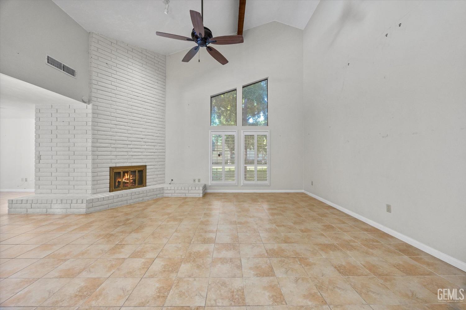 Undisclosed Address Bakersfield, CA 93309 - Photo 10 of 36 a view of an empty room with a fireplace