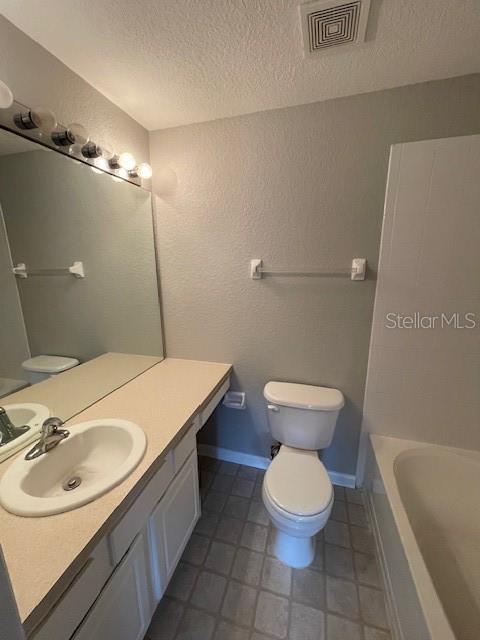 803 Shropshire Loop Sanford, FL 32771 - Photo 13 of 29 a bathroom with a sink a toilet and a mirror