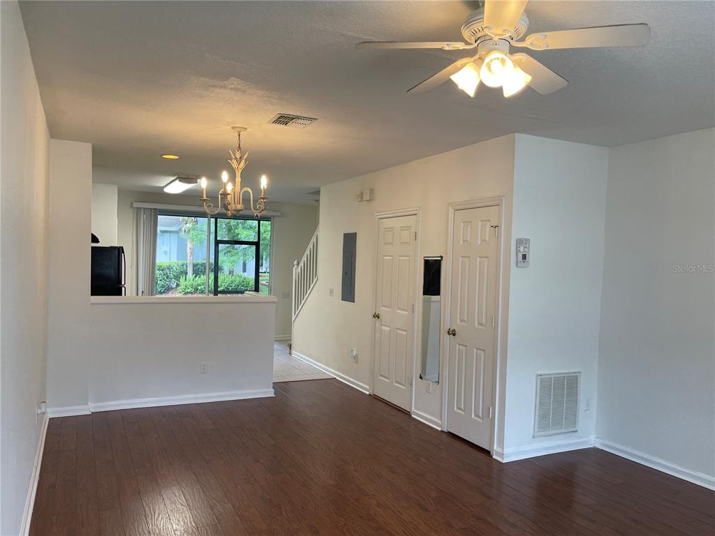 803 Shropshire Loop Sanford, FL 32771 - Photo 19 of 29 an empty room with wooden floor and hallway