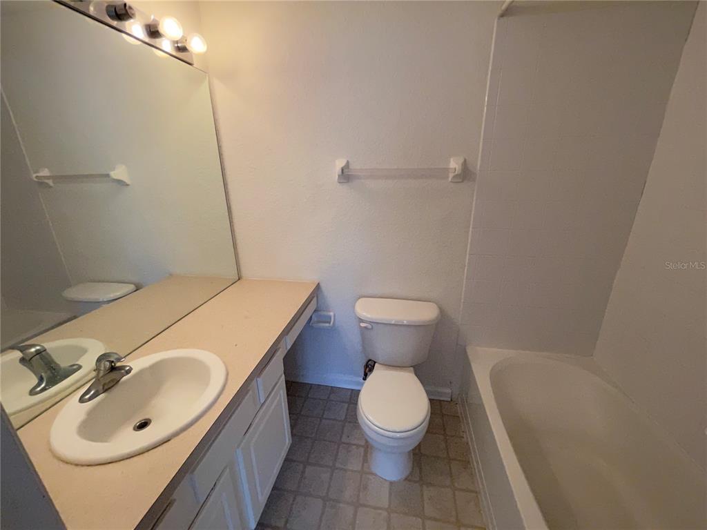 803 Shropshire Loop Sanford, FL 32771 - Photo 21 of 29 a bathroom with a sink a toilet and tub