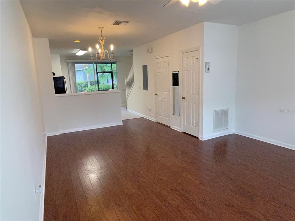 803 Shropshire Loop Sanford, FL 32771 - Photo 7 of 29 an empty room with wooden floor and windows