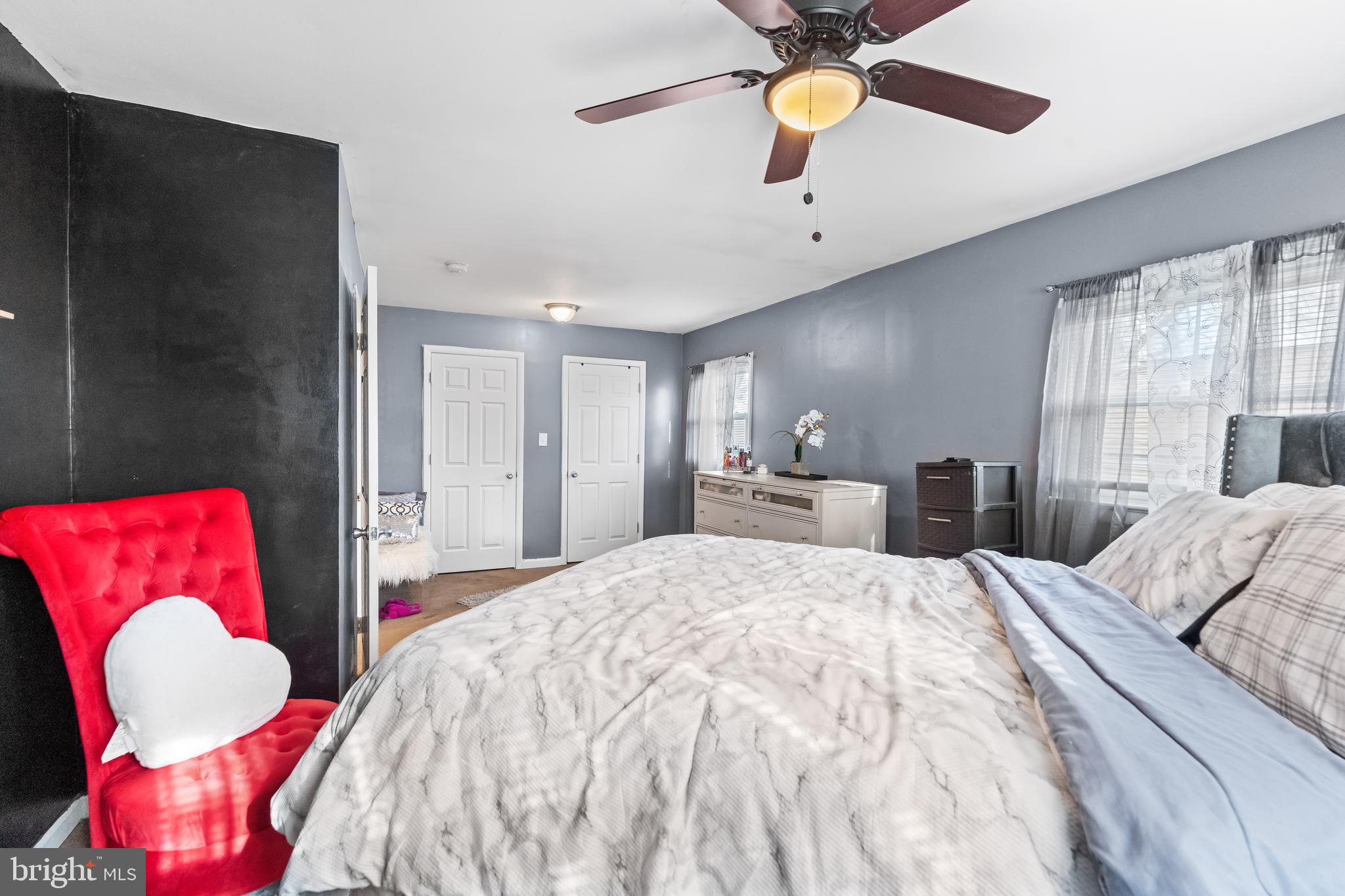 939 Clovis Avenue Capitol Heights, MD 20743 - Photo 11 of 25 a bedroom with a bed and a chandelier