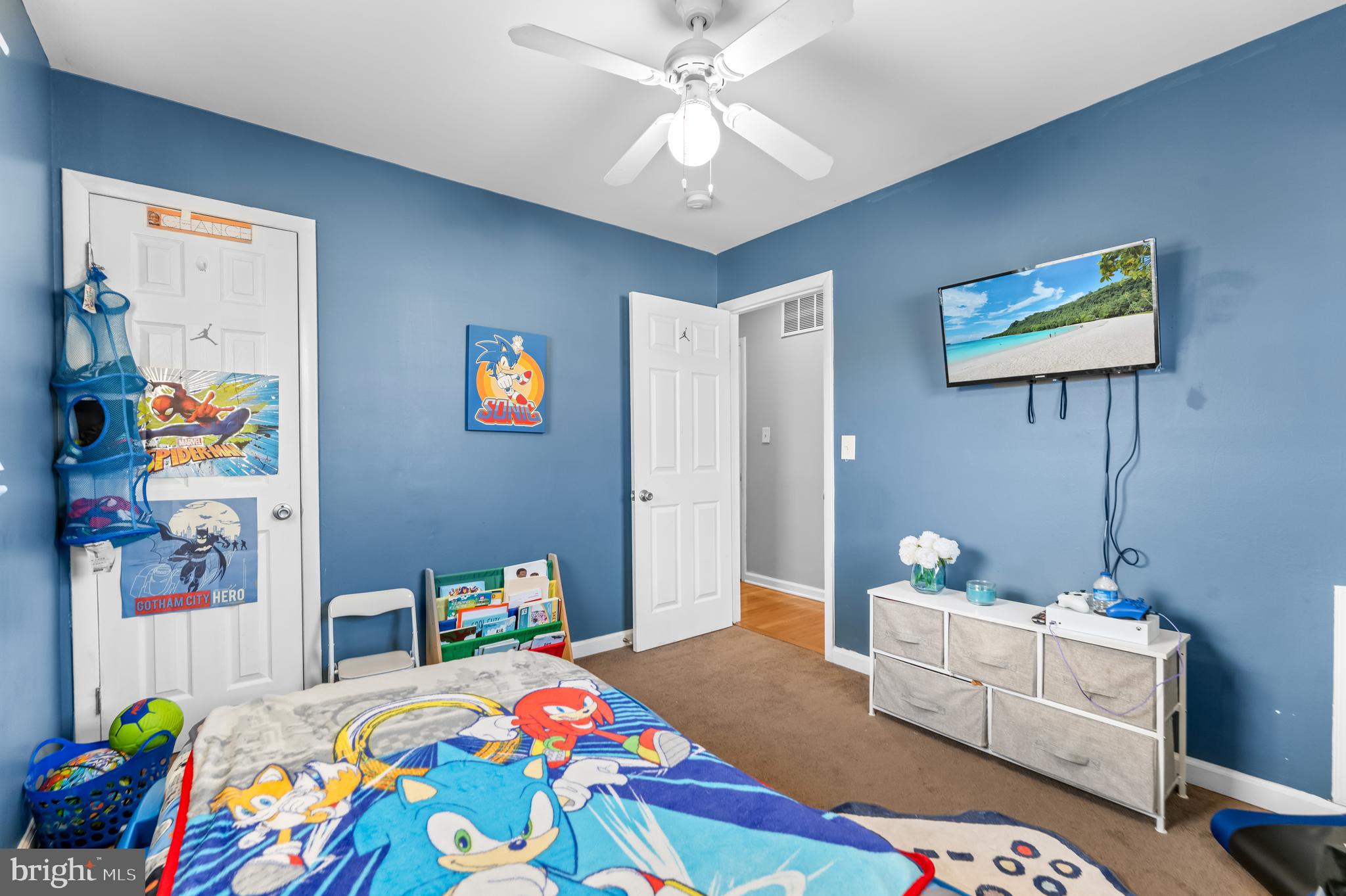 939 Clovis Avenue Capitol Heights, MD 20743 - Photo 13 of 25 a bedroom with a bed and a chandelier