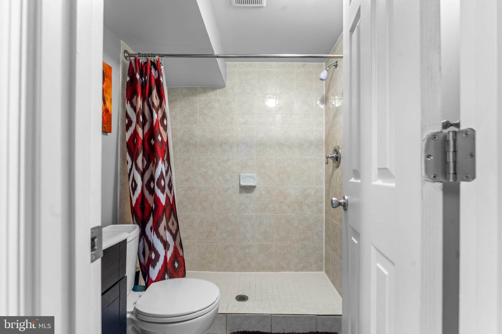 939 Clovis Avenue Capitol Heights, MD 20743 - Photo 16 of 25 a bathroom with a shower and a toilet