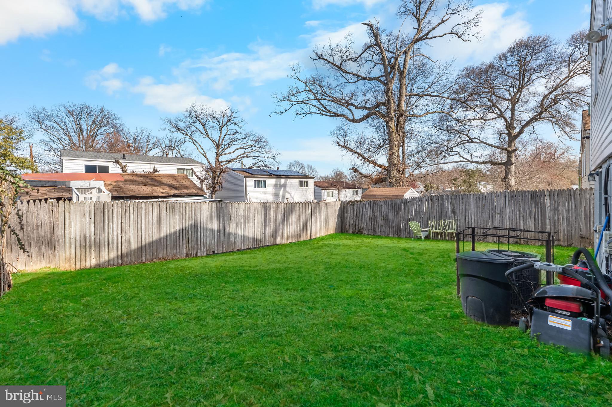 939 Clovis Avenue Capitol Heights, MD 20743 - Photo 22 of 25 a view of a backyard with table and chairs and wooden fence