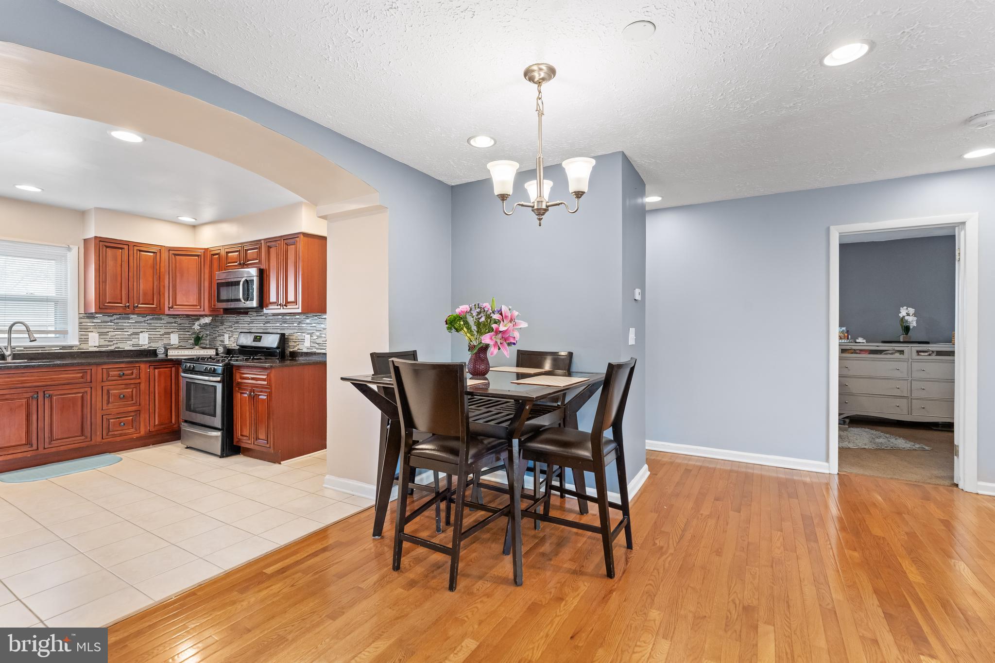 939 Clovis Avenue Capitol Heights, MD 20743 - Photo 6 of 25 a view of a dining room with furniture a chandelier and wooden floor