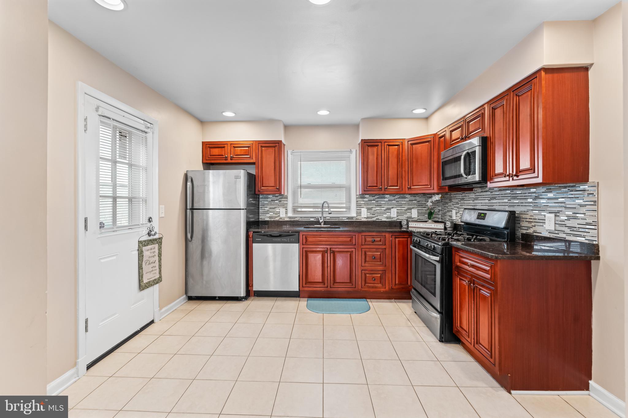 939 Clovis Avenue Capitol Heights, MD 20743 - Photo 7 of 25 a kitchen with stainless steel appliances granite countertop a refrigerator stove top oven and sink