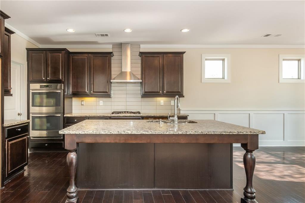5914 High Hampton Lane Mableton, GA 30126 - Photo 15 of 32 a kitchen with kitchen island granite countertop a sink stove and refrigerator