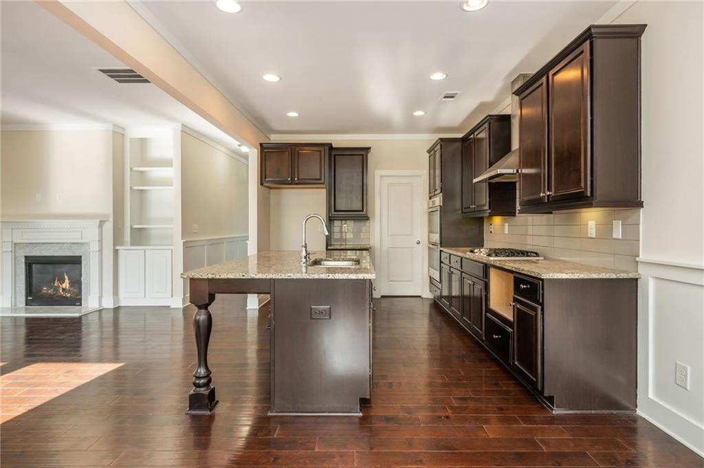 5914 High Hampton Lane Mableton, GA 30126 - Photo 16 of 32 a large kitchen with stainless steel appliances granite countertop a stove a sink and a refrigerator