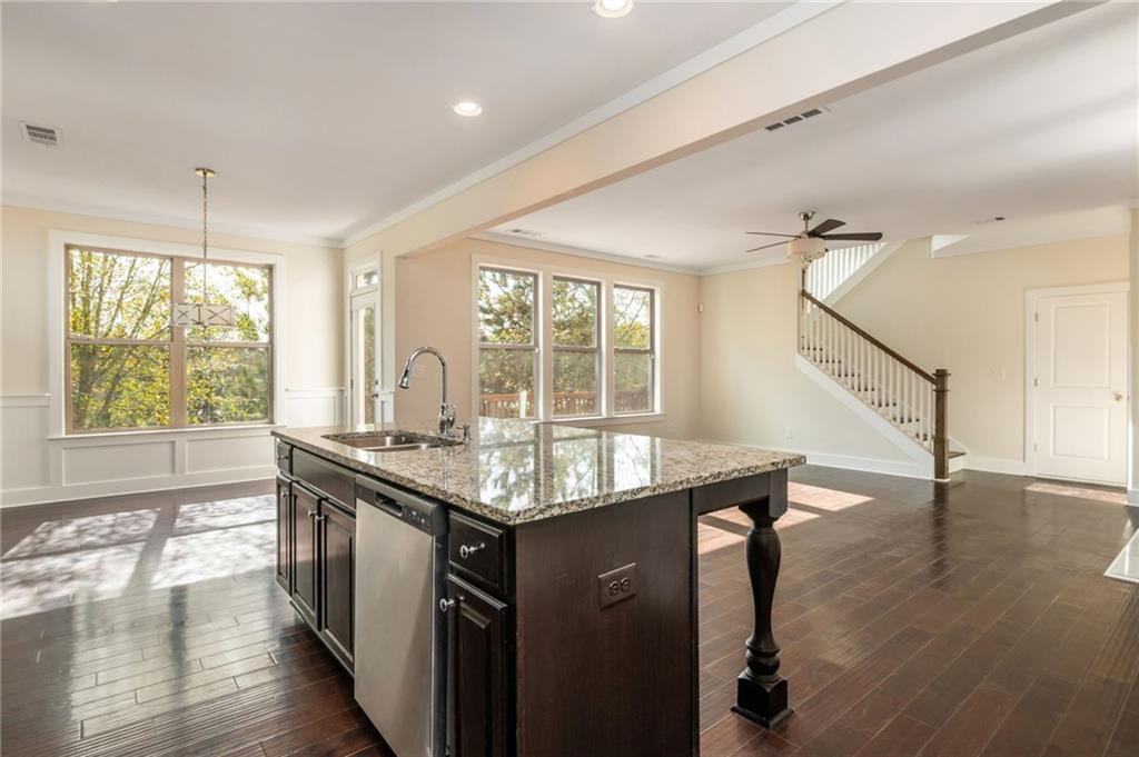 5914 High Hampton Lane Mableton, GA 30126 - Photo 17 of 32 a kitchen with stainless steel appliances granite countertop a sink a stove and wooden floor