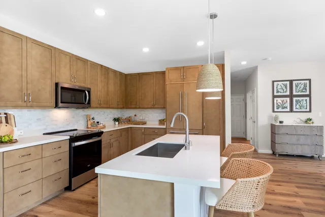 a kitchen with granite countertop a sink a counter space appliances and cabinets