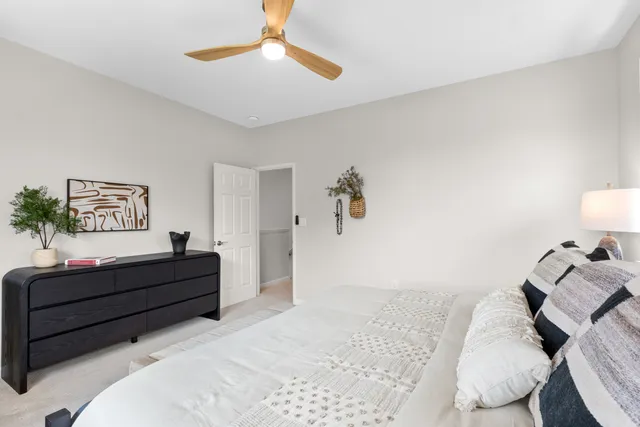 a bedroom with a bed and a painting on the wall