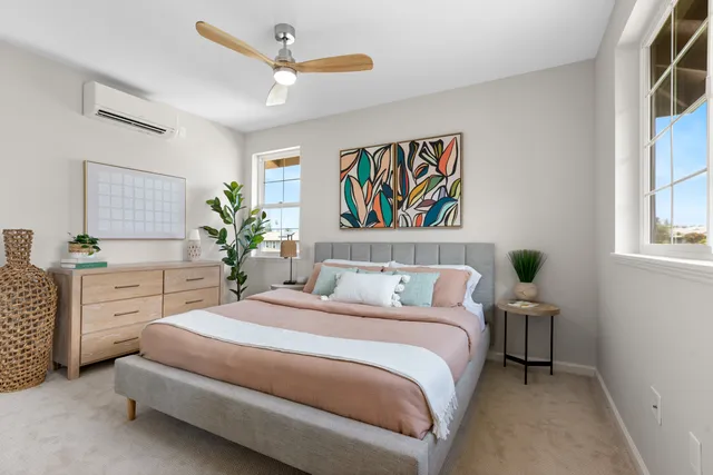 a spacious bedroom with a bed and a dresser