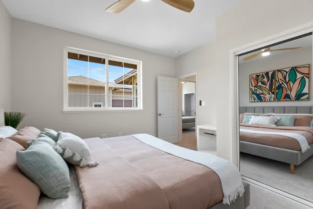 a bedroom with a large bed and a window