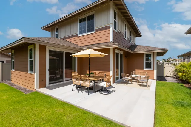a view of a house with backyard sitting area and porch