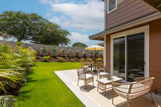 a view of swimming pool with outdoor seating and a garden