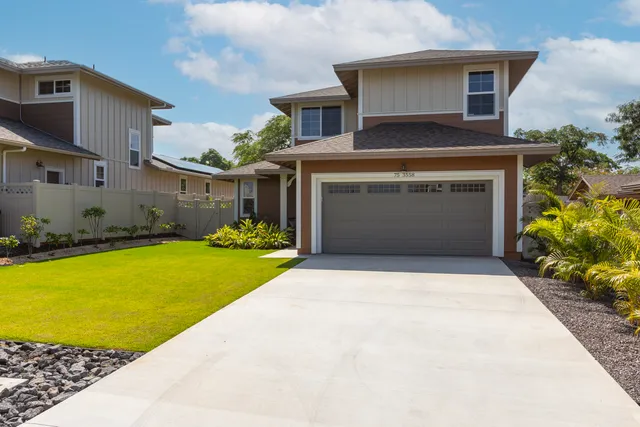 a front view of a house with garden
