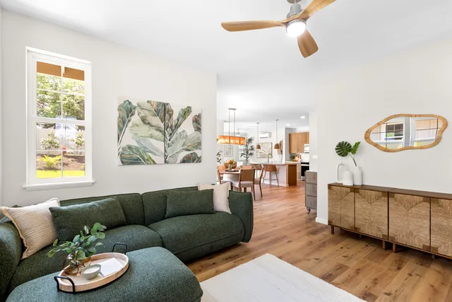 a living room with furniture and wooden floor