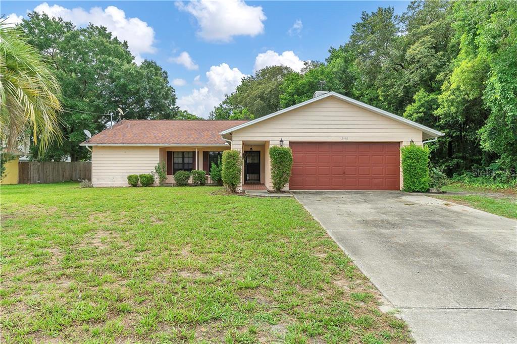 2446 Appian Avenue Spring Hill, FL 34608 - Photo 1 of 1 a front view of house with yard and green space