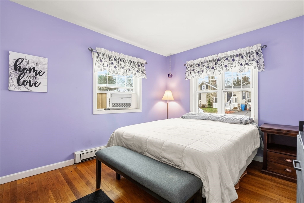 90 Loring Avenue Whitman, MA 02382 - Photo 12 of 22 a bedroom with a bed and wooden floor