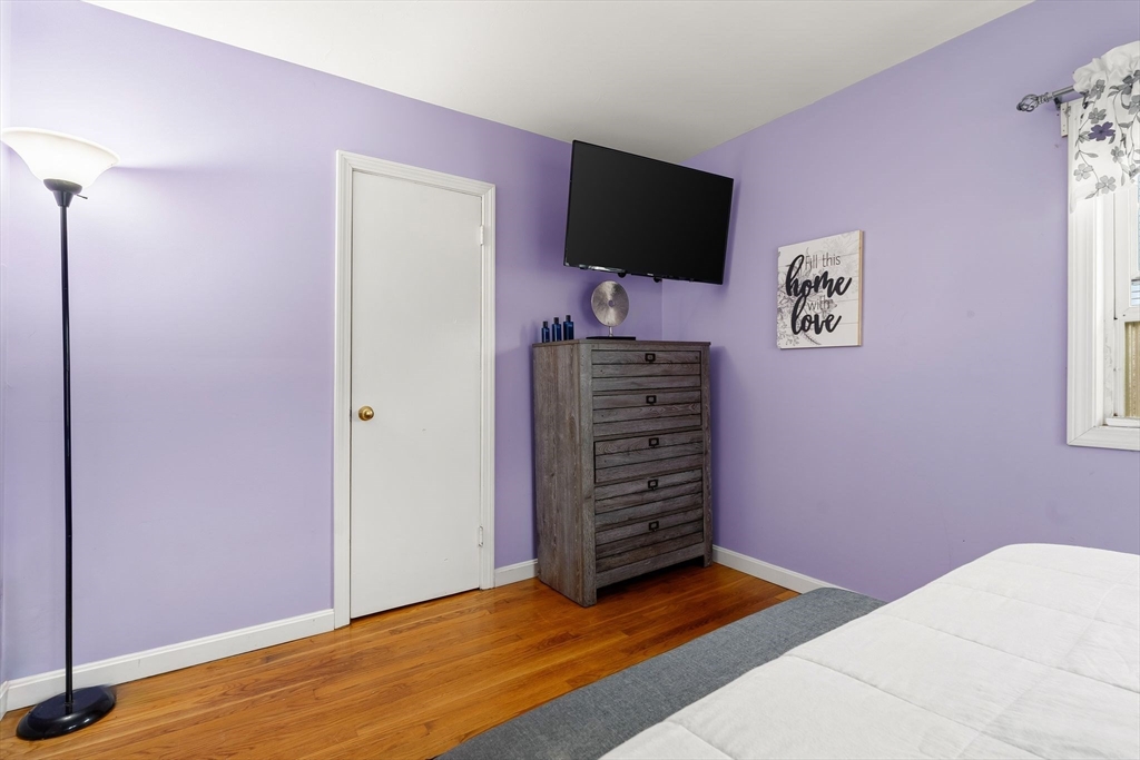 90 Loring Avenue Whitman, MA 02382 - Photo 13 of 22 a bedroom with a bed and a flat screen tv