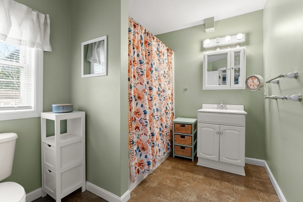 90 Loring Avenue Whitman, MA 02382 - Photo 18 of 22 a bathroom with a sink a toilet and a mirror