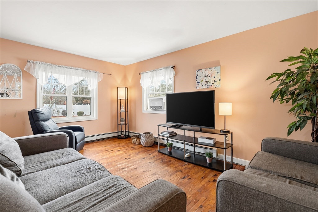 90 Loring Avenue Whitman, MA 02382 - Photo 4 of 22 a living room with furniture and a flat screen tv
