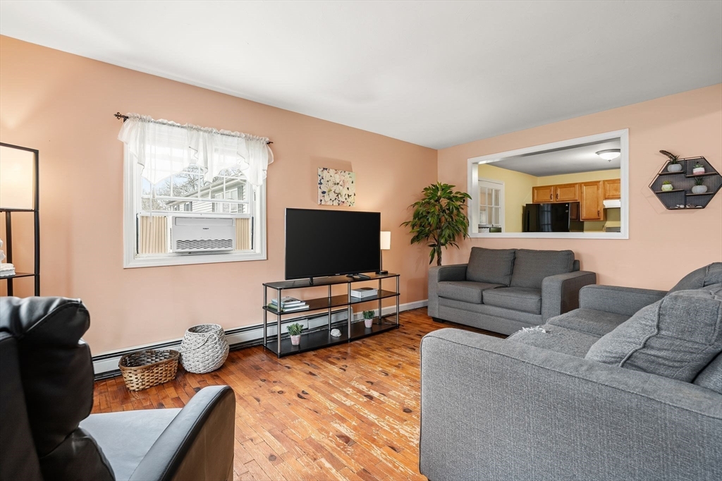 90 Loring Avenue Whitman, MA 02382 - Photo 5 of 22 a living room with furniture and a flat screen tv