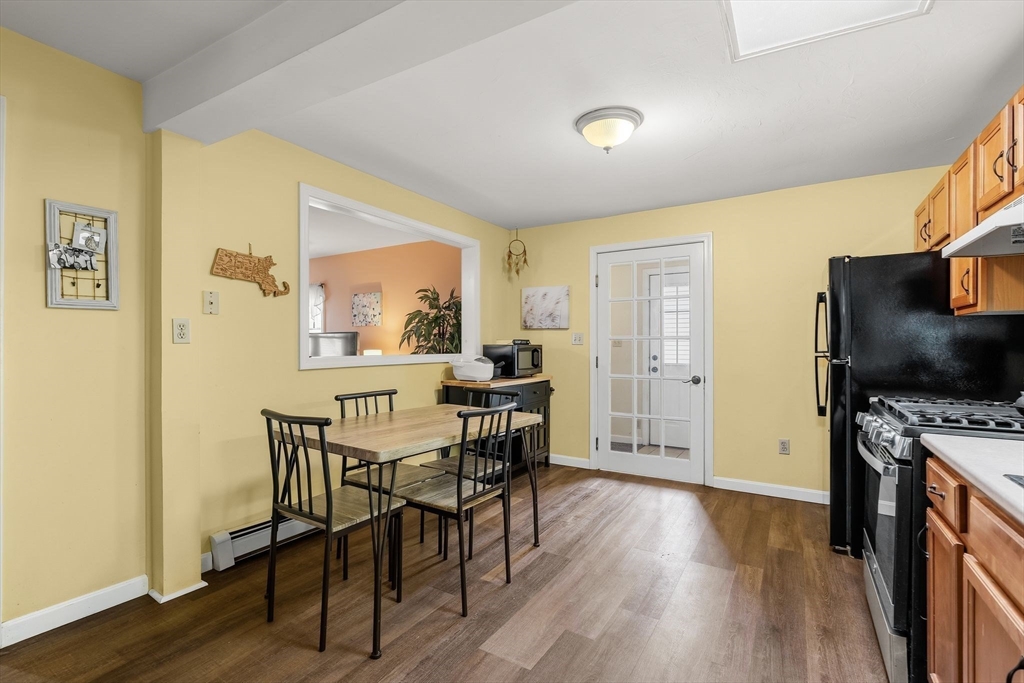 90 Loring Avenue Whitman, MA 02382 - Photo 10 of 22 a view of a dining room with furniture and wooden floor