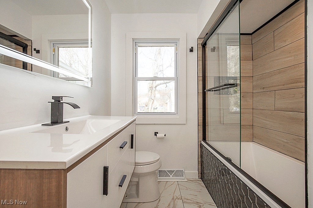 4441 Anderson Road Cleveland, OH 44121 - Photo 15 of 35 Full Bath, Ceramic Tile Floor, Built In Linen Space, Large Vanity With Storage, Led Vanity Mirror, Tiled Shower/Bath With Sliding Glass Doors