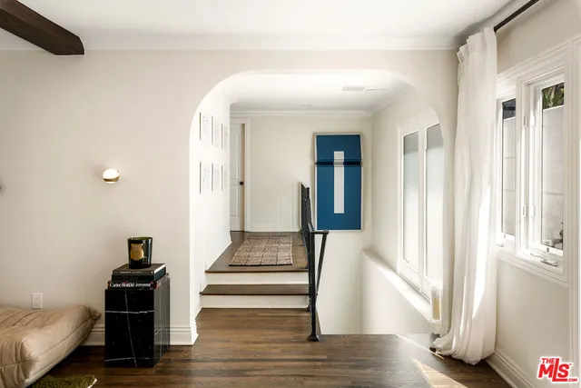 a view of a hallway with wooden floor and staircase