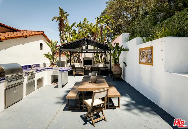 a view of a house with pool and chairs